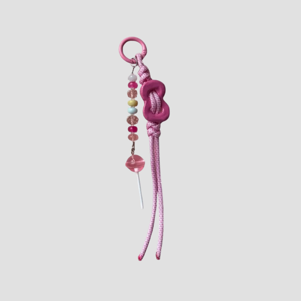 Pink keychain with beads on a white background