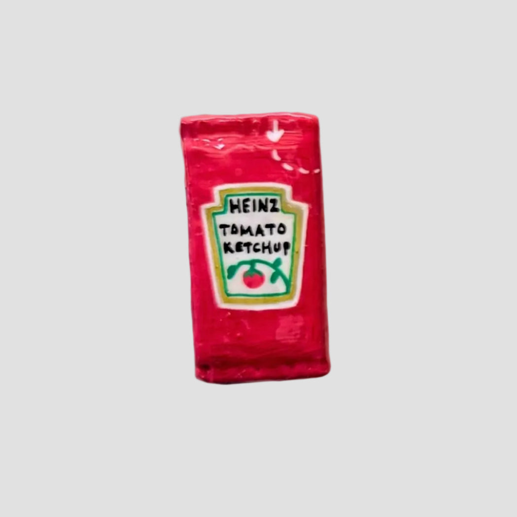 Red Heinz Tomato Ketchup packet on a white background
