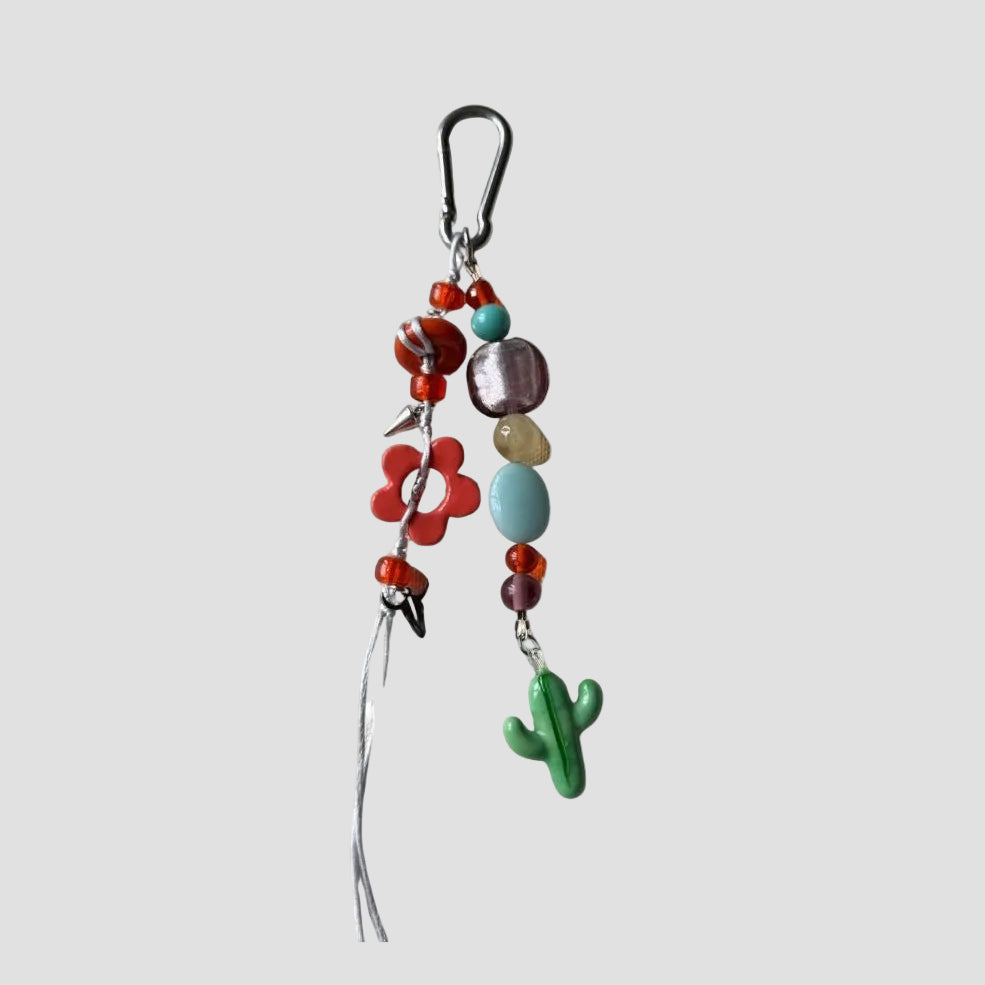 Colorful beaded keychain with a cactus charm on a white background
