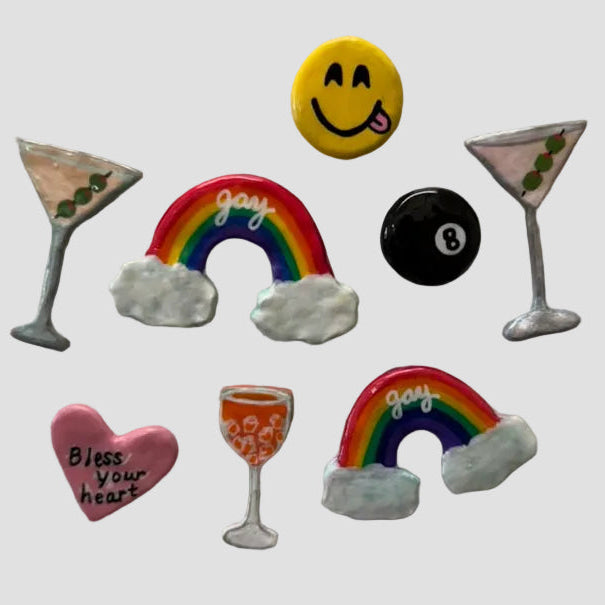 Collection of colorful refrigerator magnets on a white surface