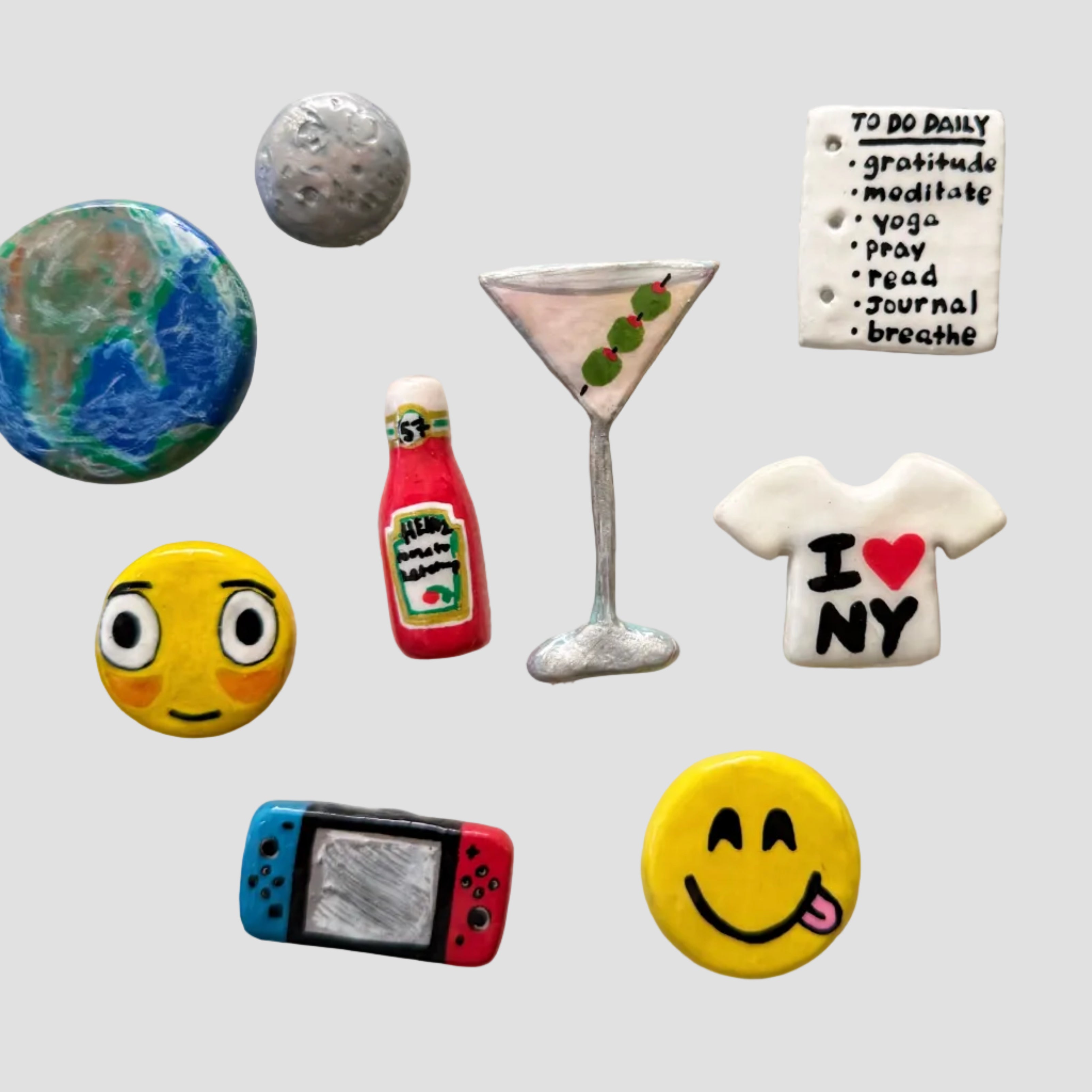 Collection of colorful refrigerator magnets on a white surface with photos in frames.